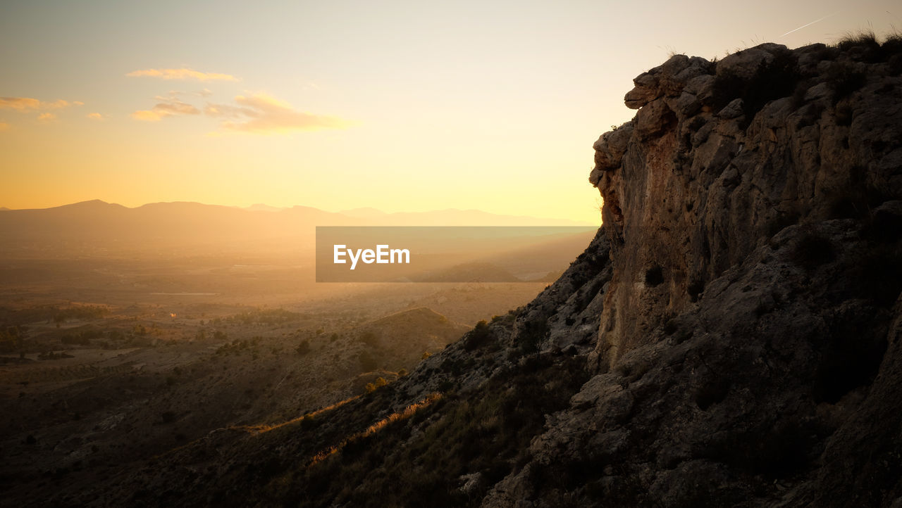 Scenic view of mountains against sky during sunset