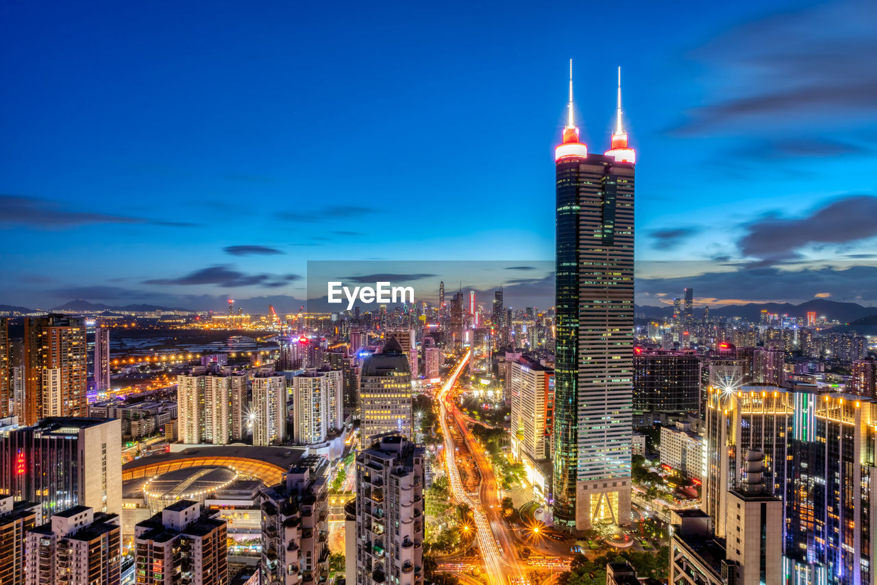 AERIAL VIEW OF ILLUMINATED BUILDINGS IN CITY