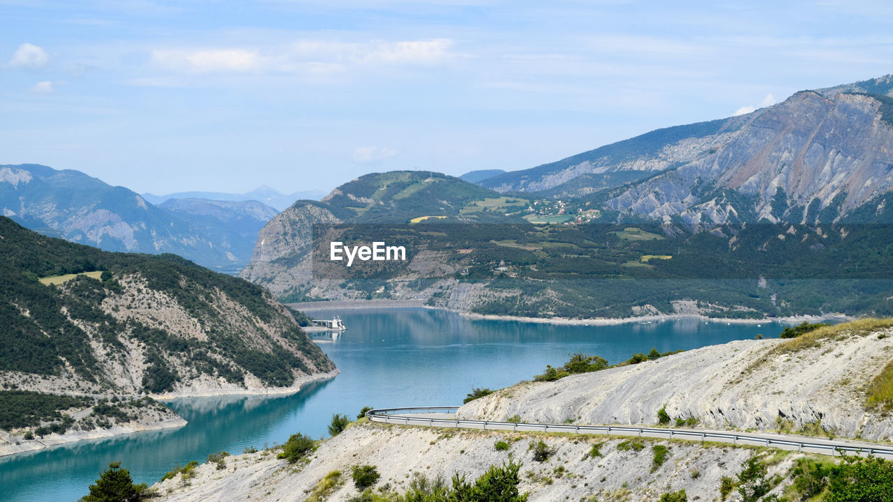 Scenic view of lake and mountains against sky