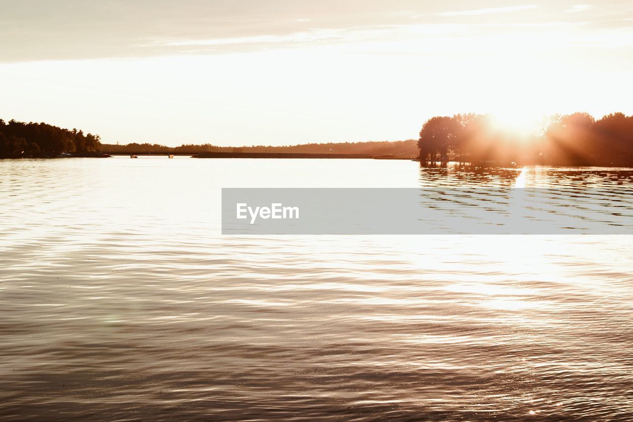 Scenic view of lake against sky during sunset