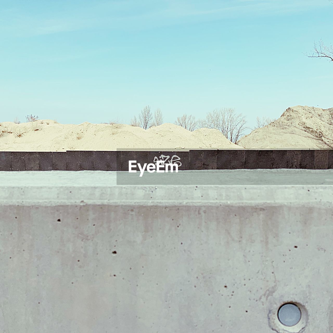 TEXT ON CONCRETE WALL AGAINST CLEAR SKY