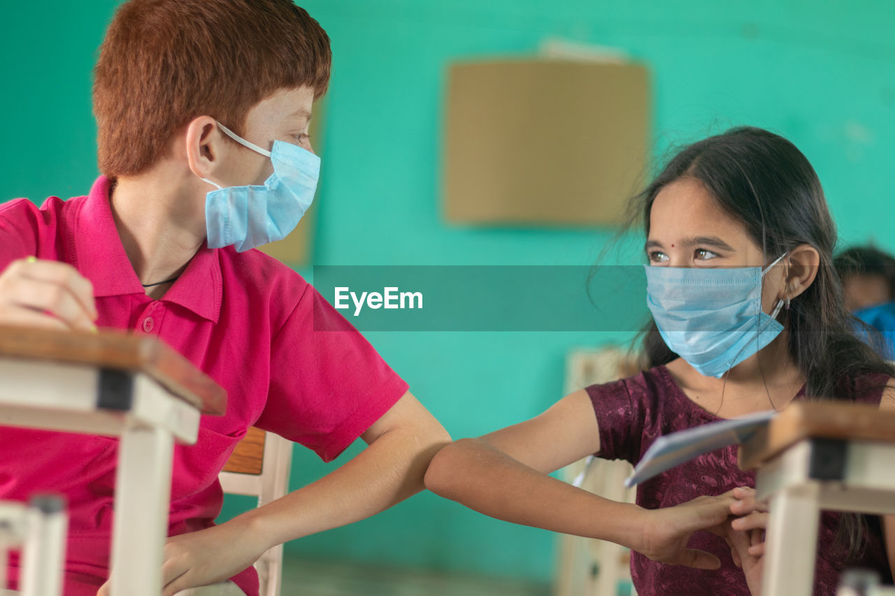 Close-up of girl and boy in classroom