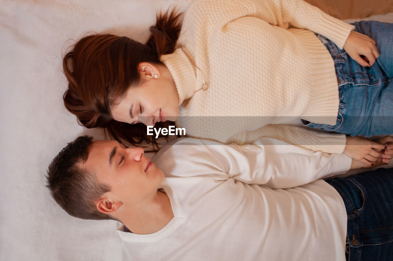 A young couple in love in a photo studio. christmas scenery, guy and girl love each other. 