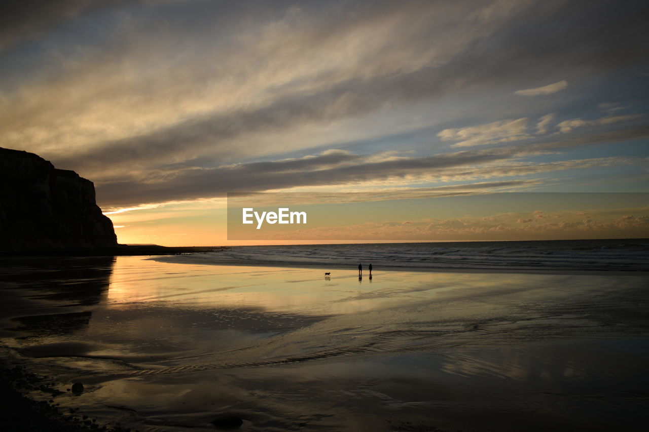 Scenic view of beach against sky during sunset