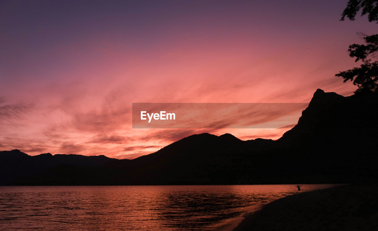 Scenic view of lake against romantic sky at sunset