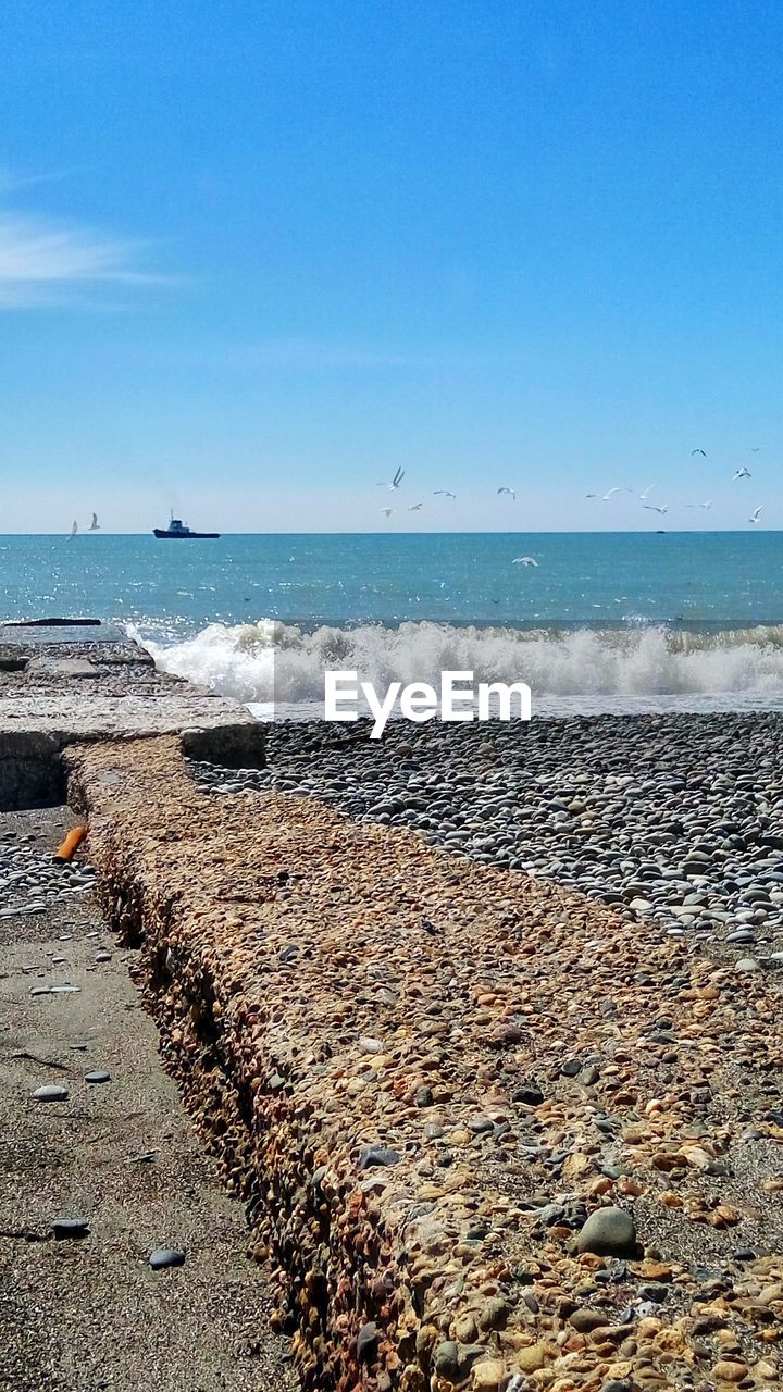 SCENIC VIEW OF BEACH BY SEA AGAINST SKY