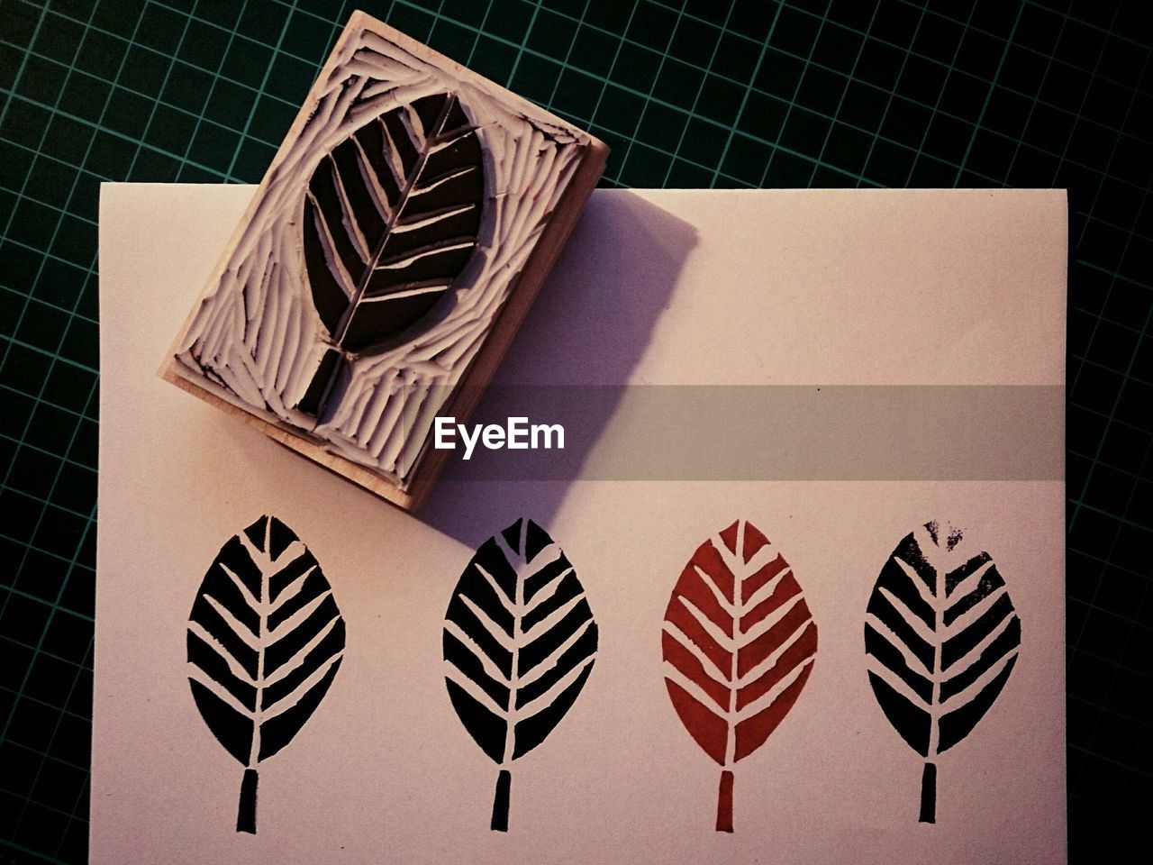 High angle view of leaf rubber stamp on table