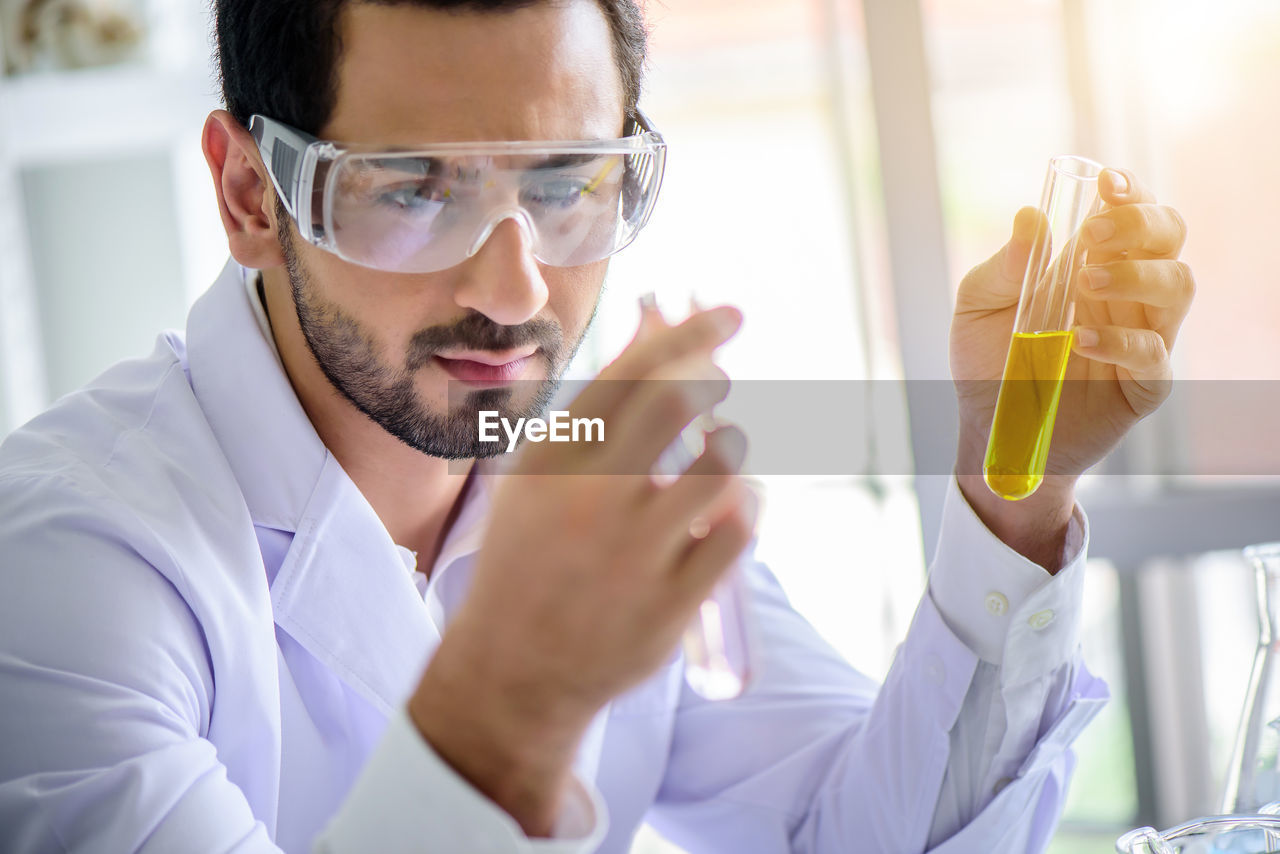 Scientist looking at chemicals in test tubes