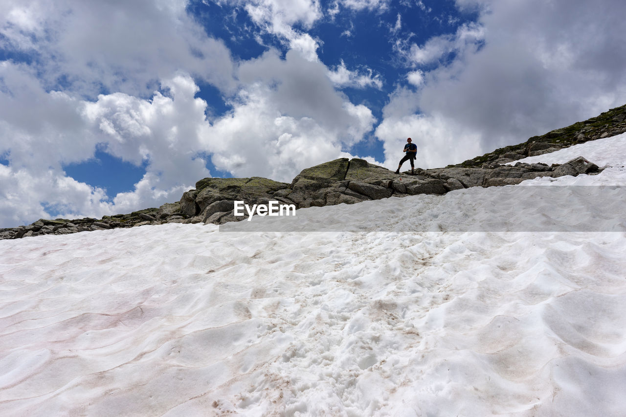Man standing on land against sky