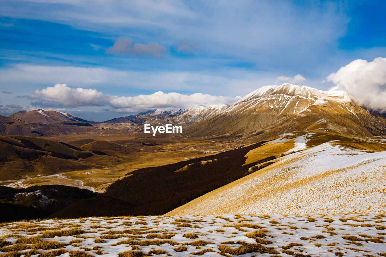 Scenic view of snowcapped mountains against sky