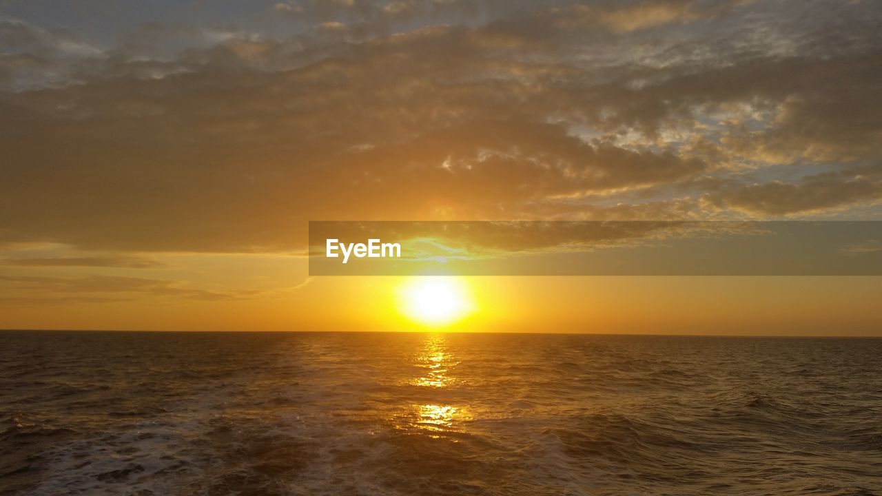 SCENIC VIEW OF SUNSET OVER SEA