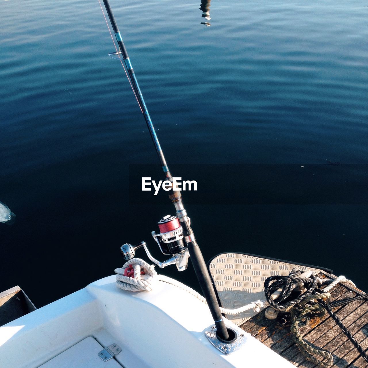 High angle view of fishing rod on boat in lake