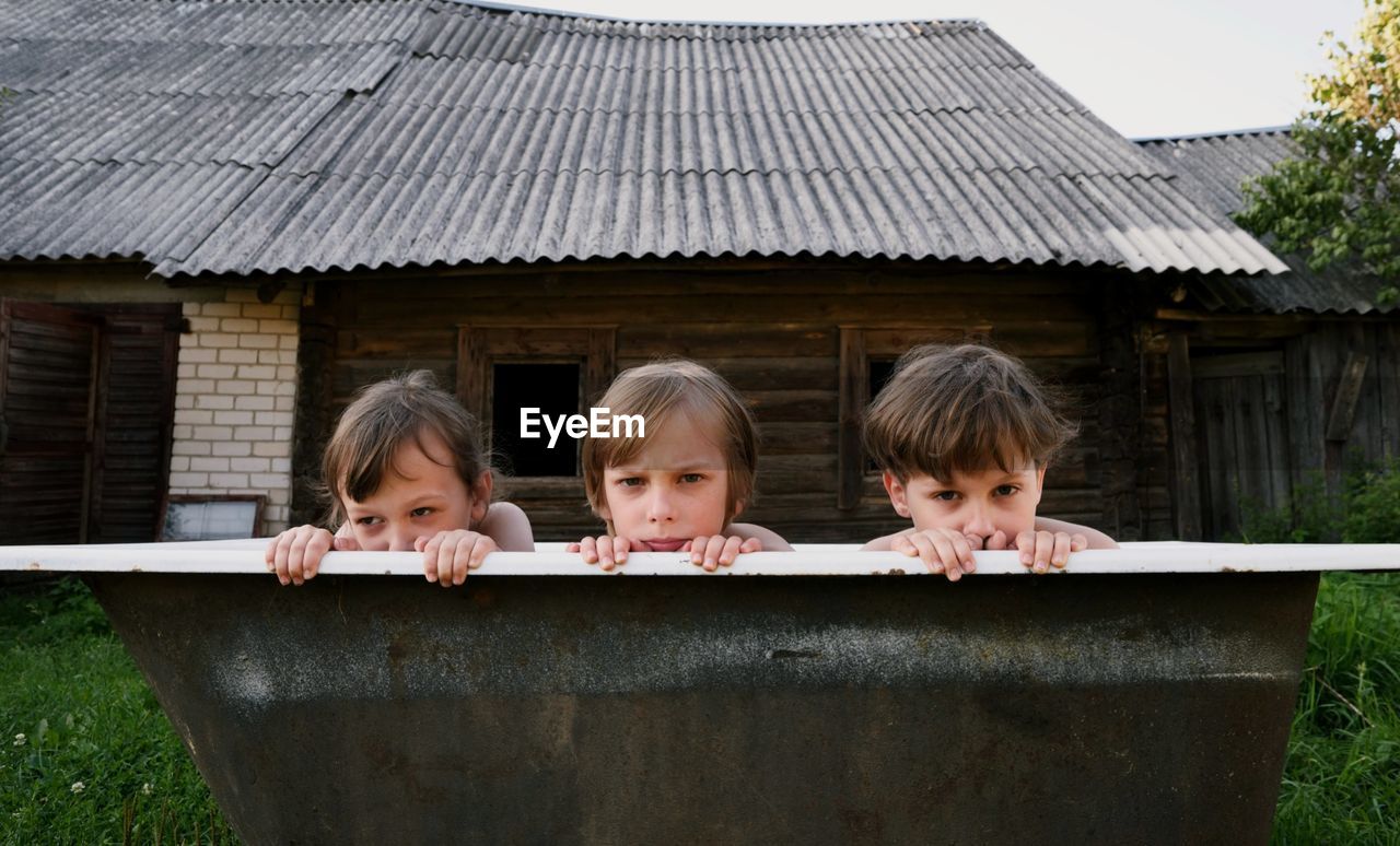 Portrait of siblings in bathtub