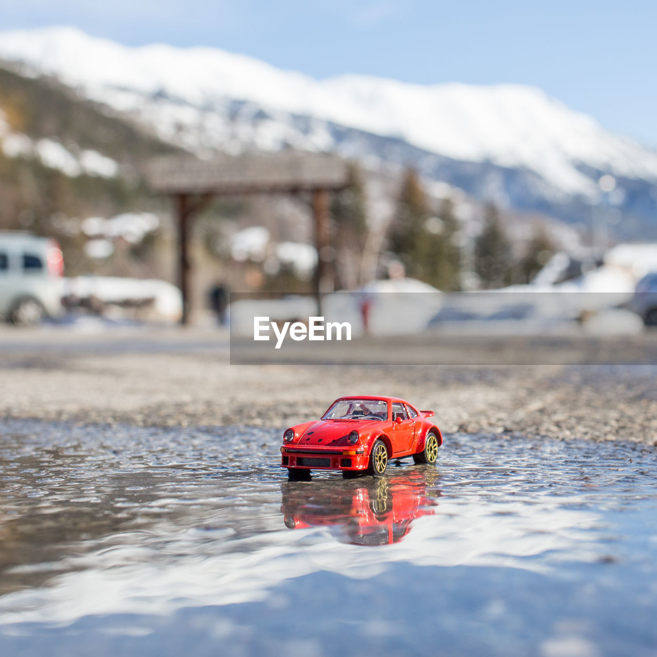 CLOSE-UP OF RED CAR ON WATER