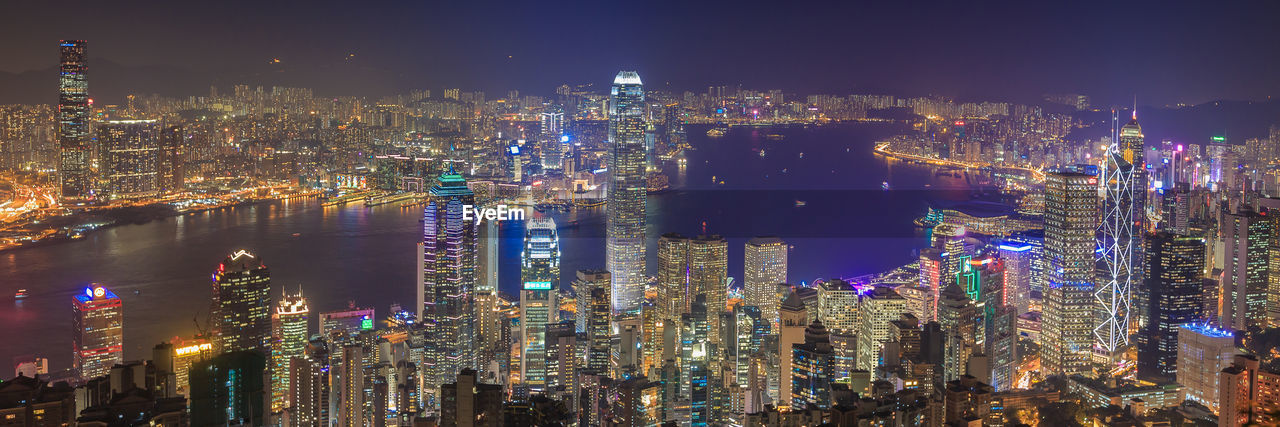 Illuminated cityscape against sky at night