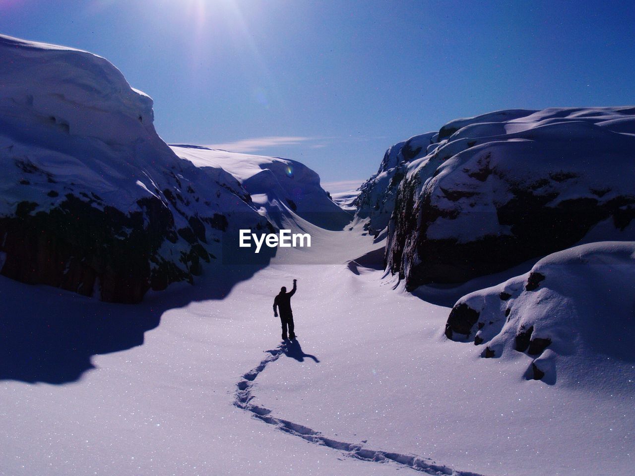 Tourist on snow covered mountain