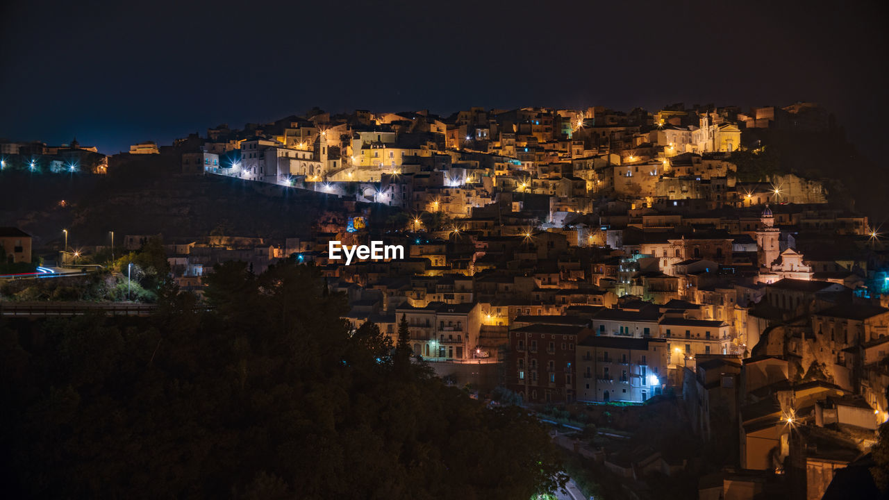 High angle view of illuminated buildings in city at night