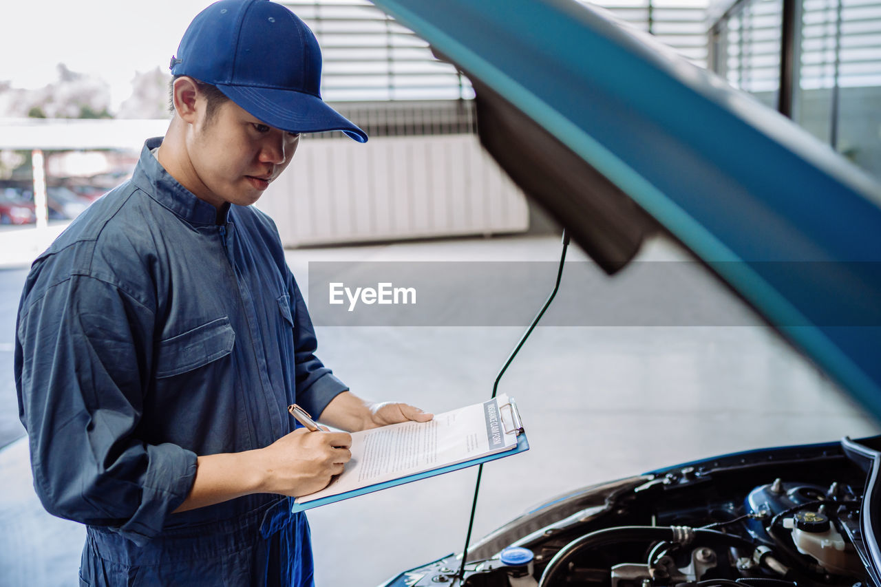 Mechanic examining car in garage