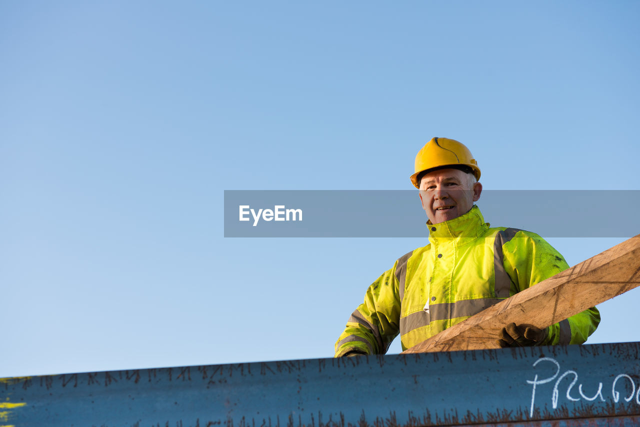 LOW ANGLE VIEW OF A MAN WORKING