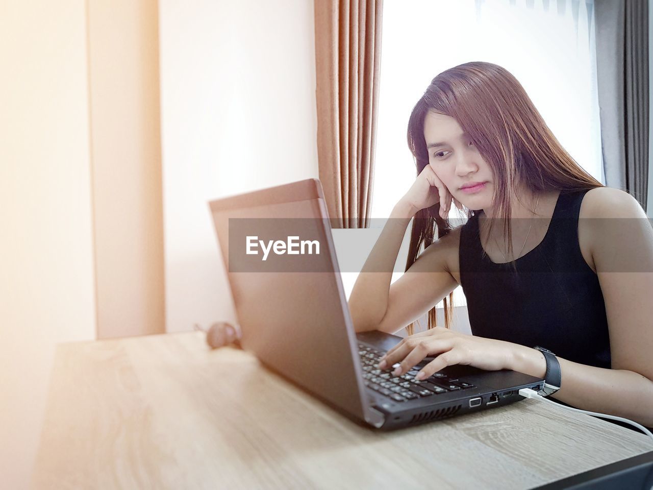 Woman using laptop at desk