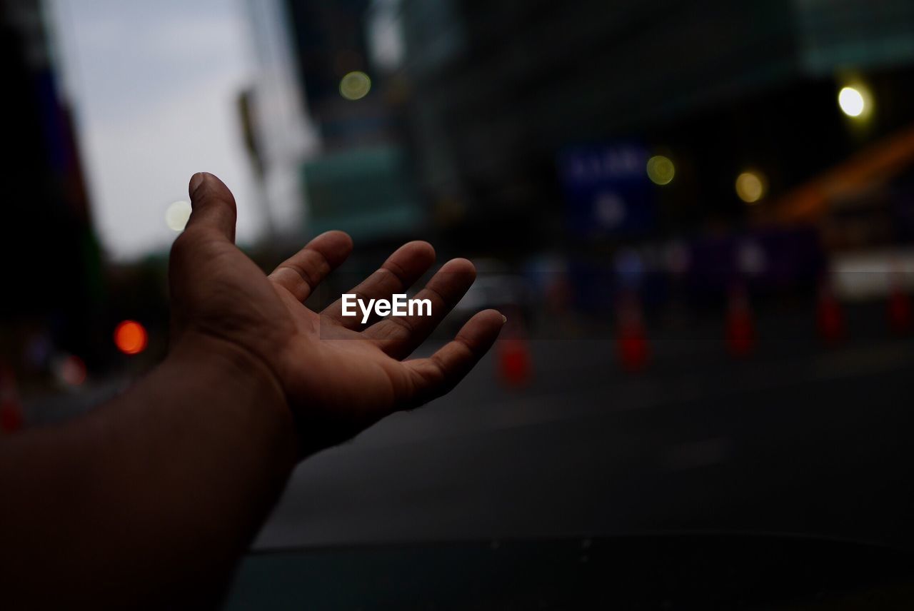 Close-up of hand on road