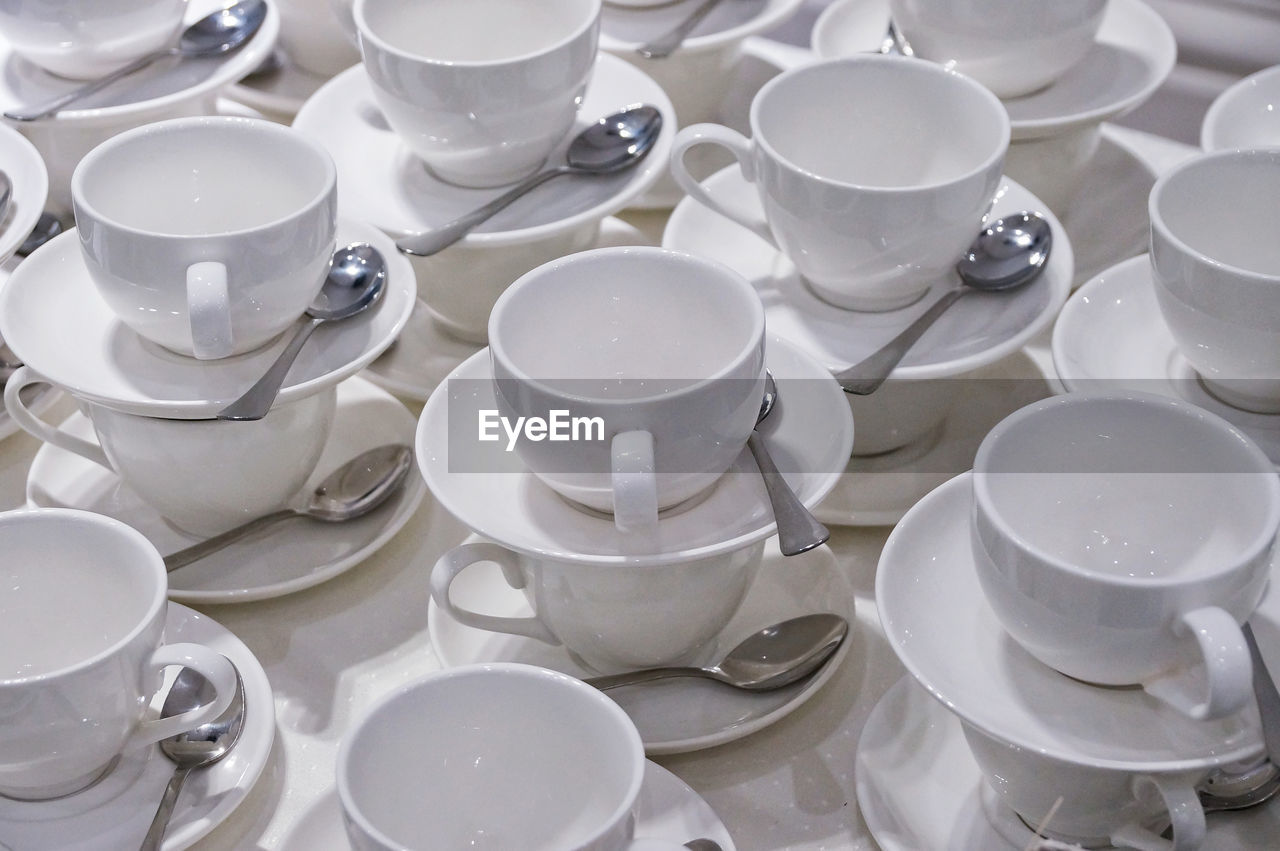 Full frame shot of empty coffee cups with spoons
