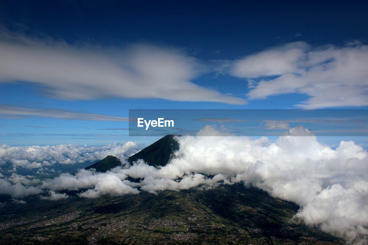Scenic view of mount sundoro amidst clouds against sky seen from mount sumbing