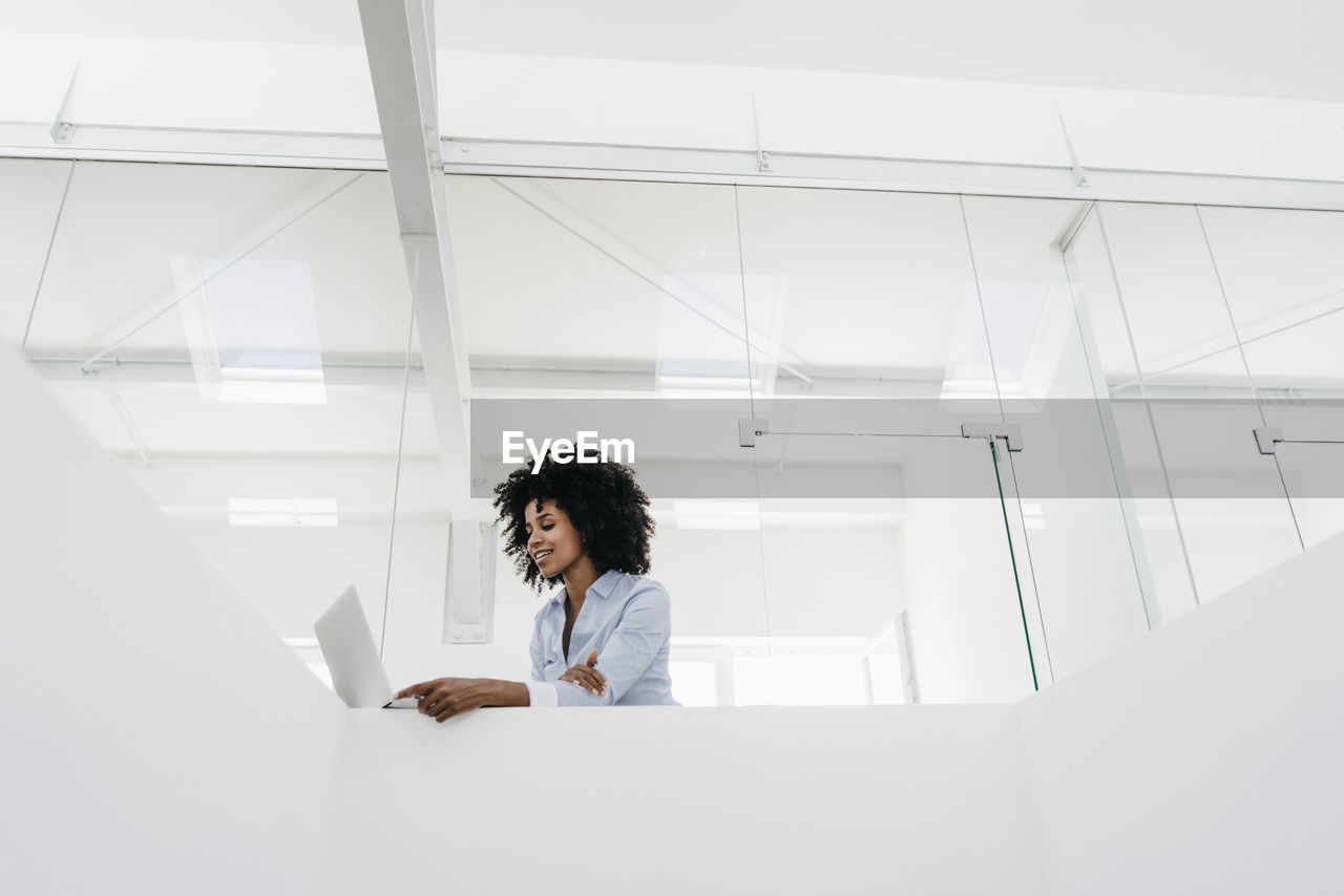 Young woman using laptop in office