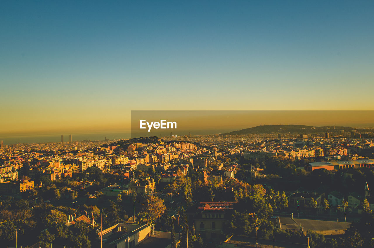 High angle shot of townscape against sky at sunset