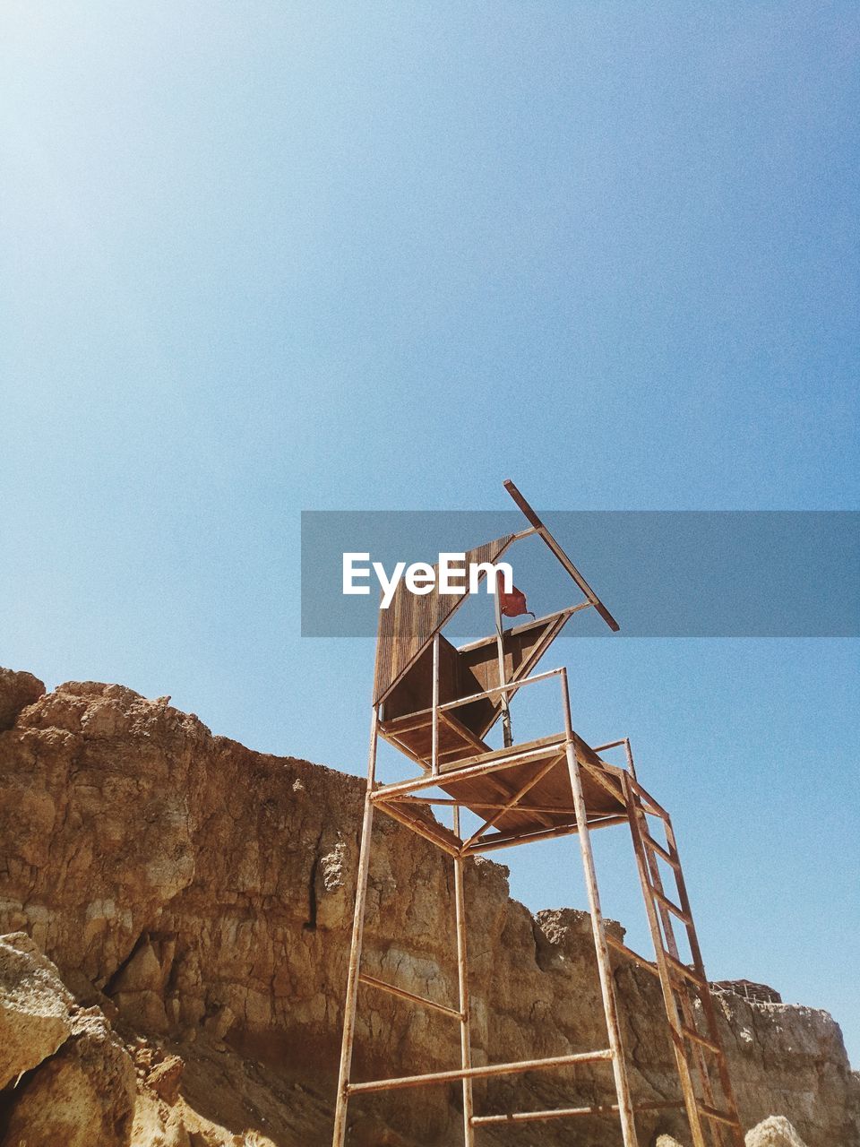LOW ANGLE VIEW OF WINDMILL ON MOUNTAIN AGAINST SKY