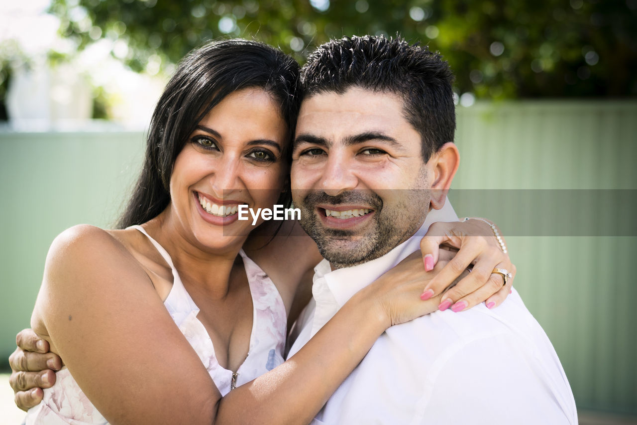 Portrait of smiling couple embracing