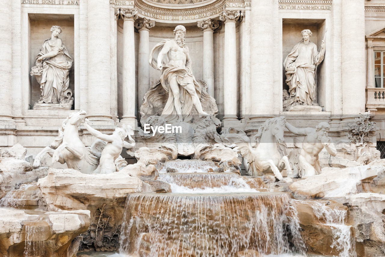 Statues and fountain outside historical building