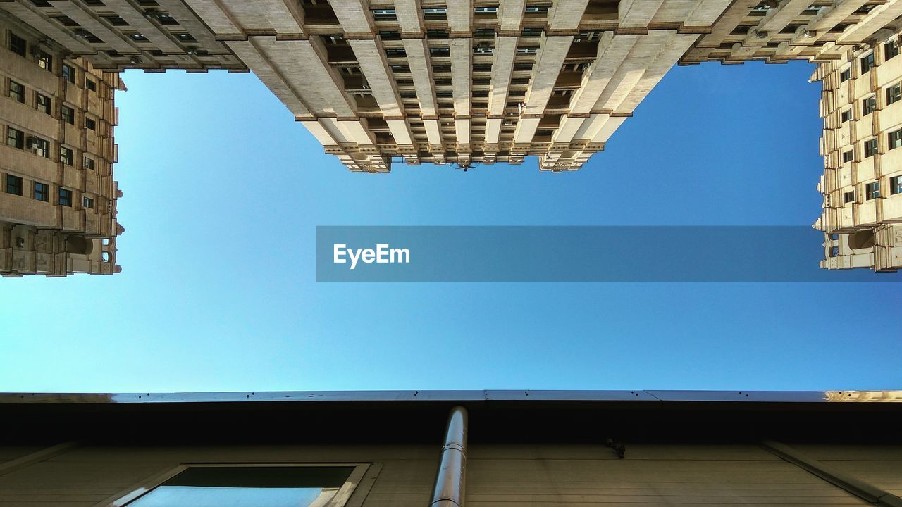 Low angle view of buildings against blue sky