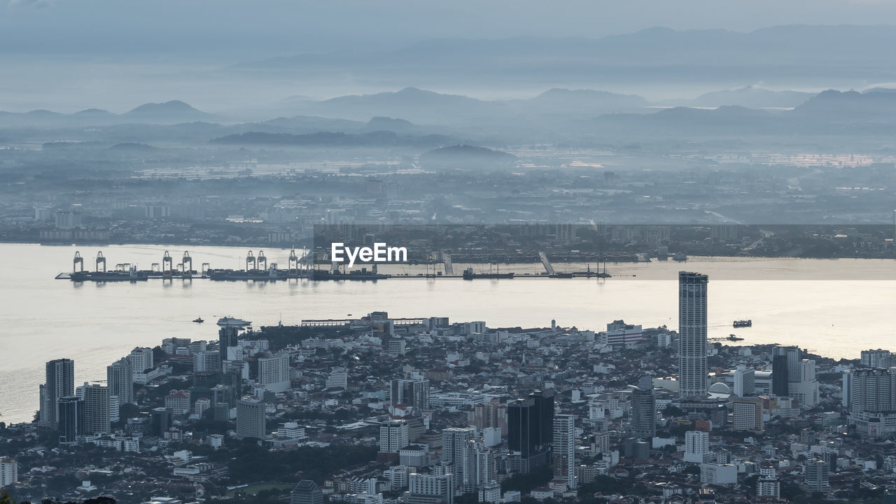 High angle view of buildings and mountains against sky