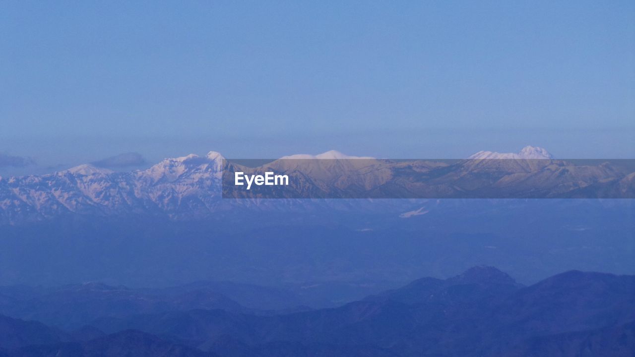 SCENIC VIEW OF MOUNTAIN RANGE AGAINST BLUE SKY