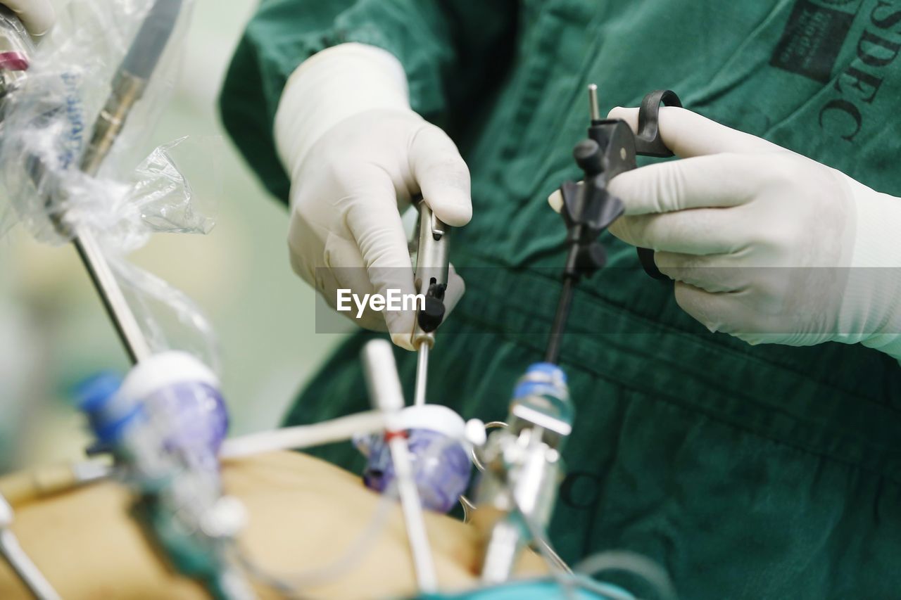 Midsection of doctor operating on patient in operating room