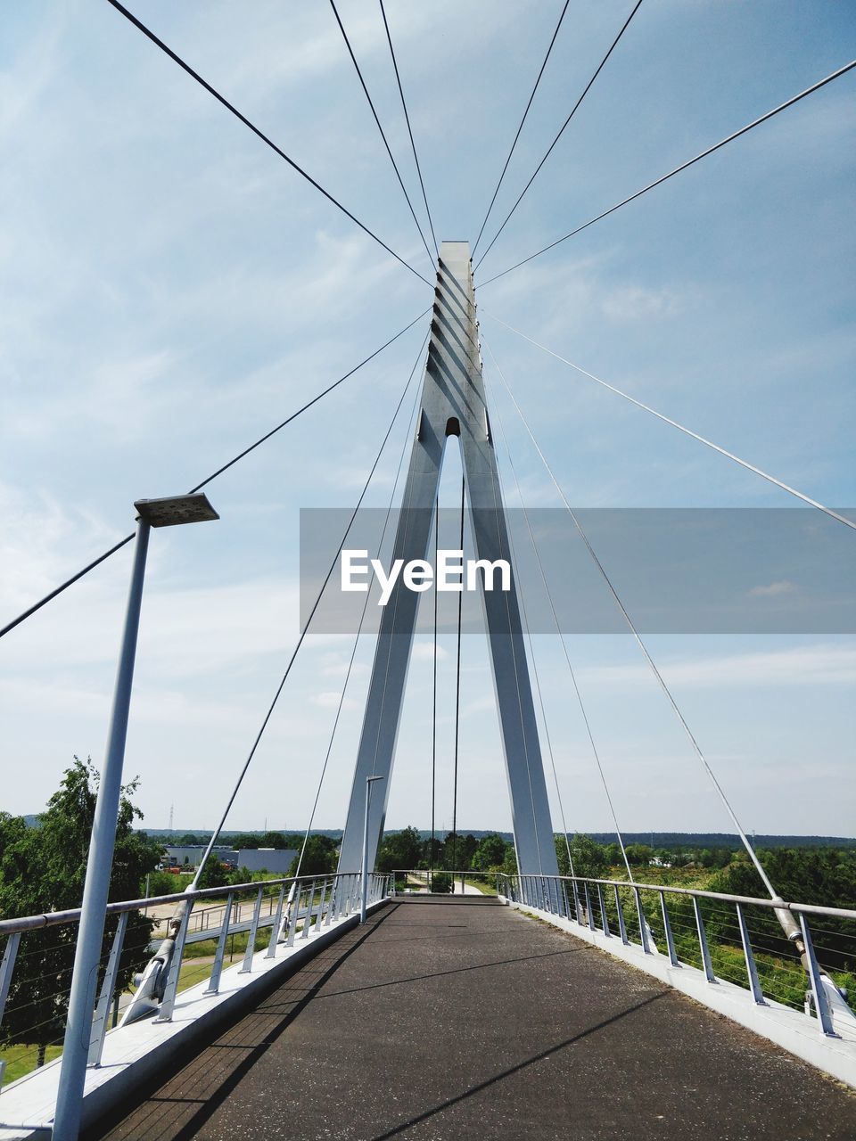 Low angle view of suspension bridge against sky
