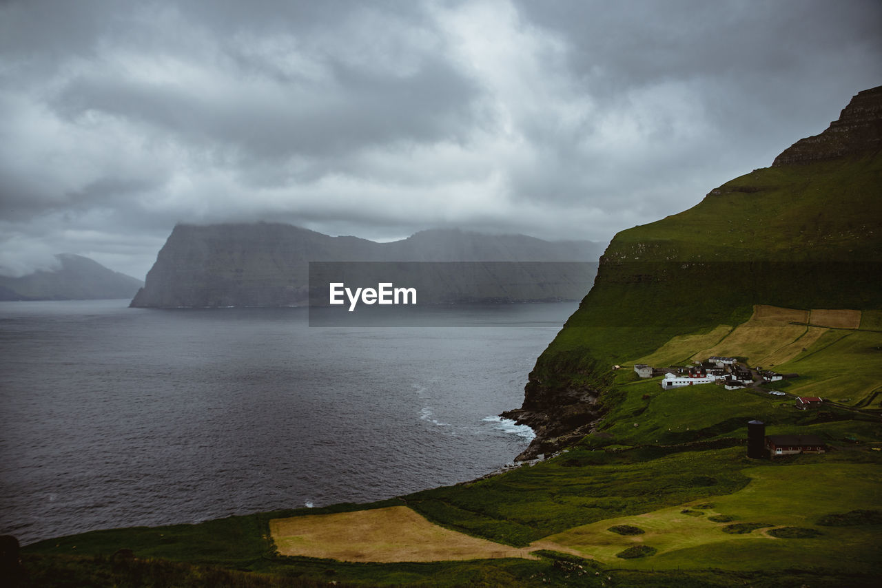 Scenic view of land and mountains against sky