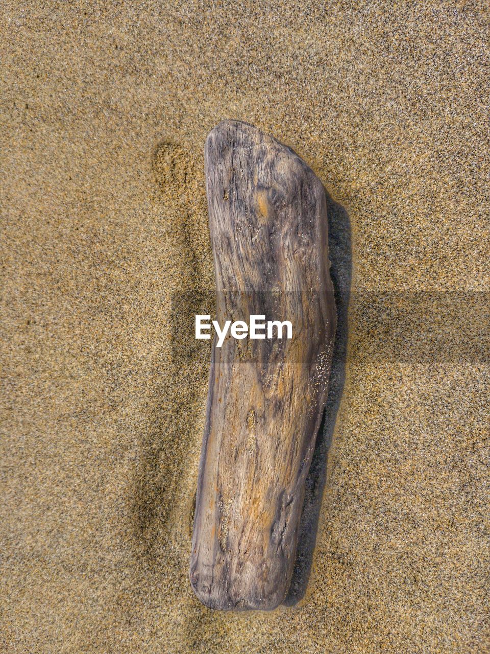 HIGH ANGLE VIEW OF WATER ON SAND