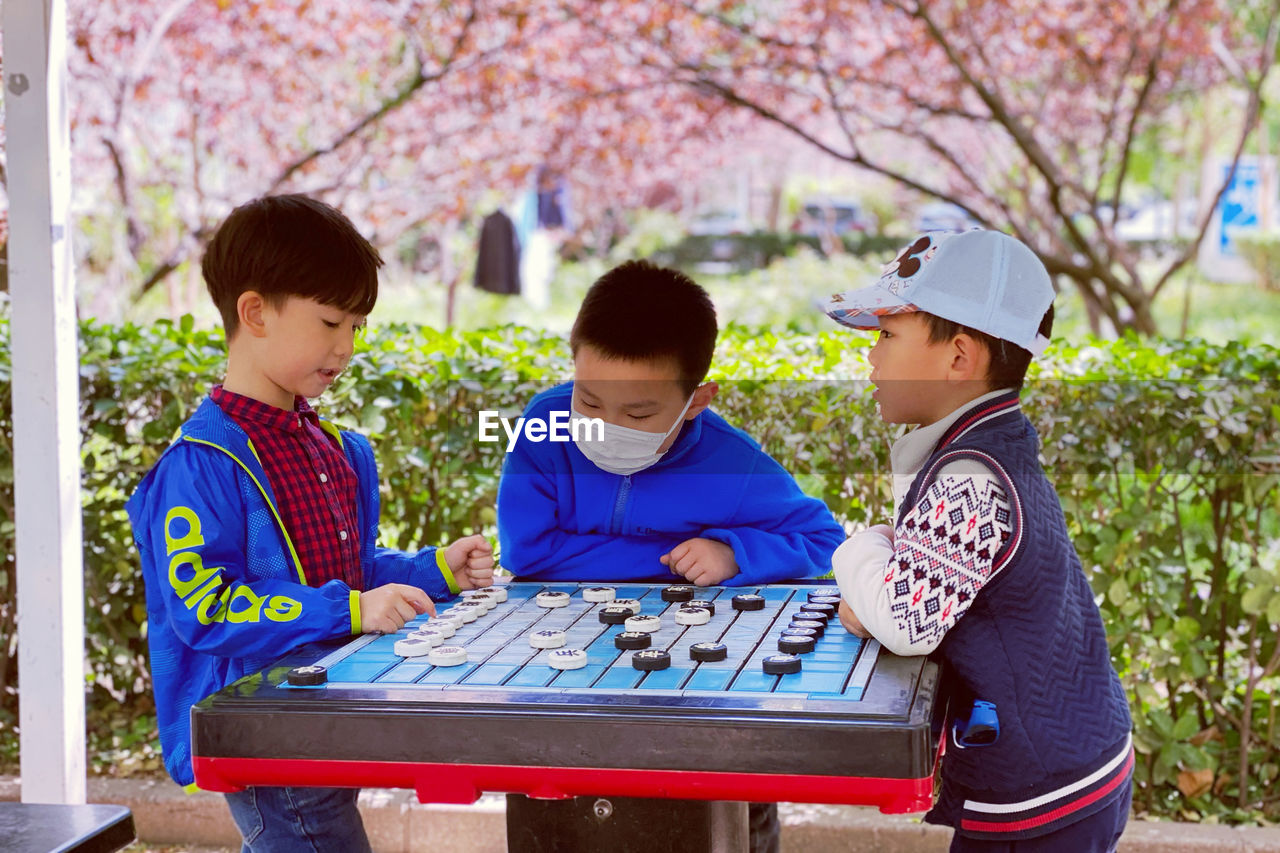 BOY LOOKING AT TREES