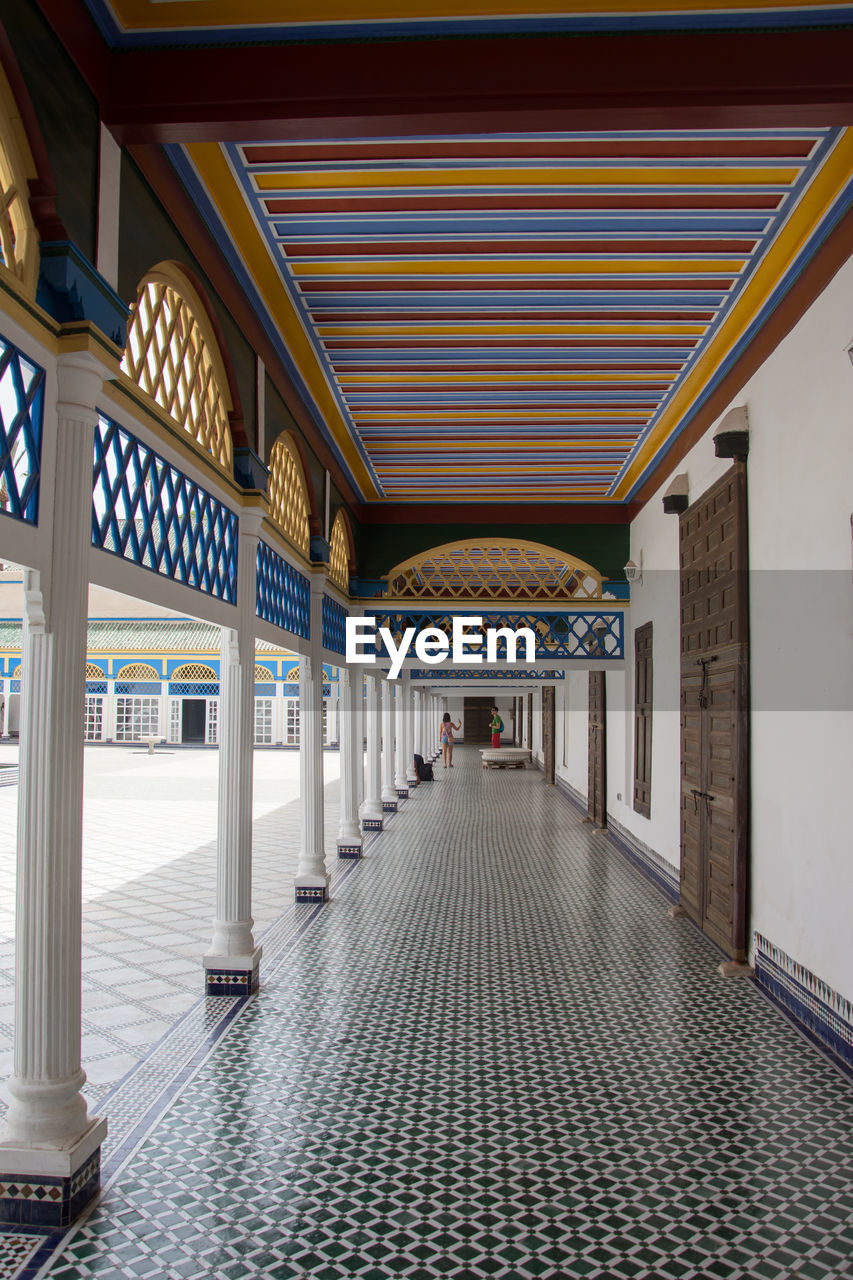 EMPTY CORRIDOR OF BUILDING WITH COLONNADE