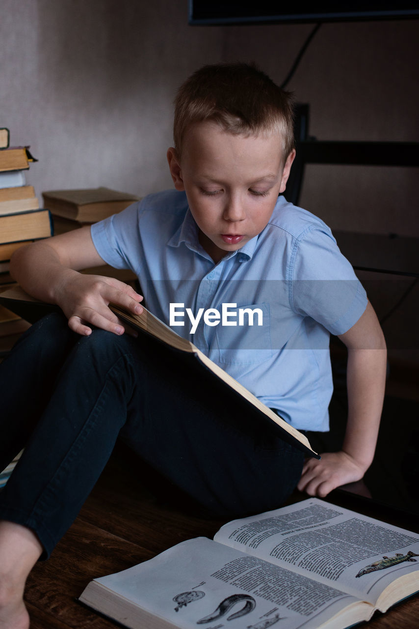 boy drawing on book