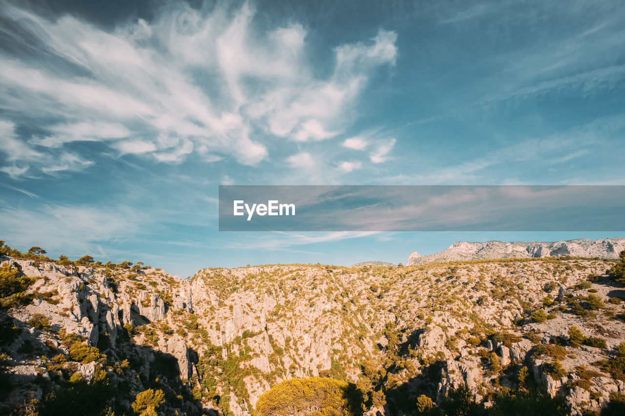 scenic view of rocks on landscape against sky