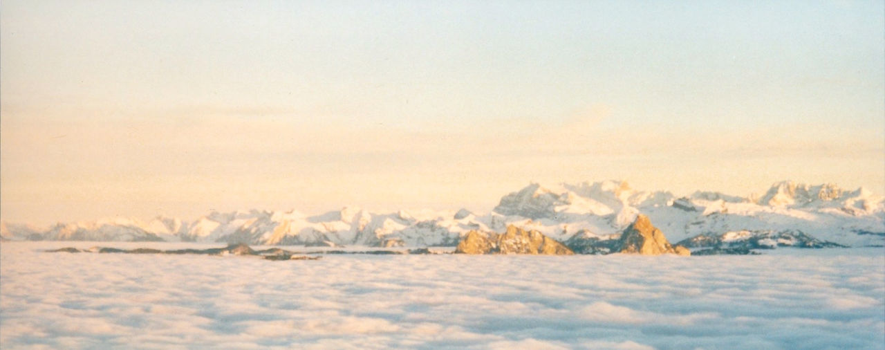 Frozen landscape against sky during winter