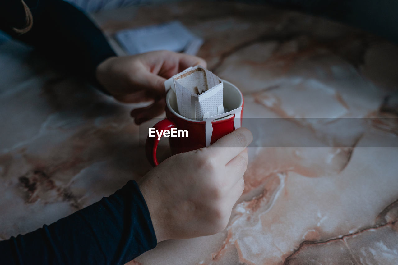 In a red mug homemade coffee filter, alternative brewing of the drink