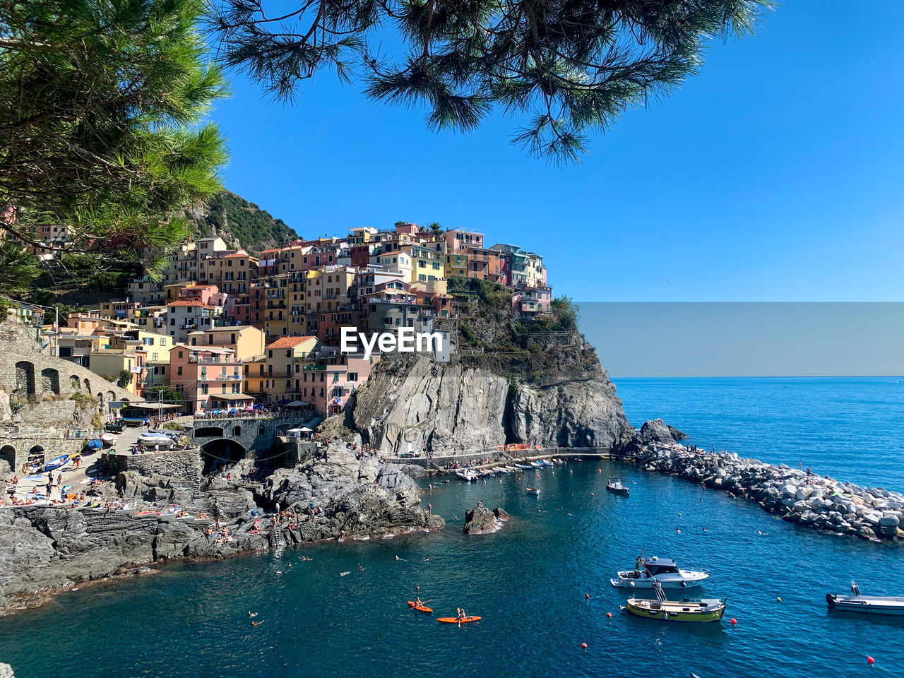 Panoramic view of sea and buildings against clear blue sky