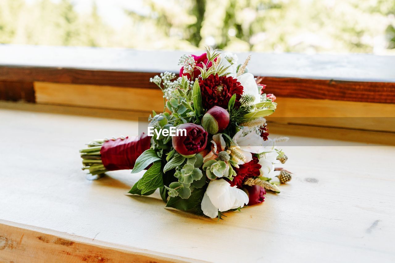 Close-up of rose and peony bouquet on table