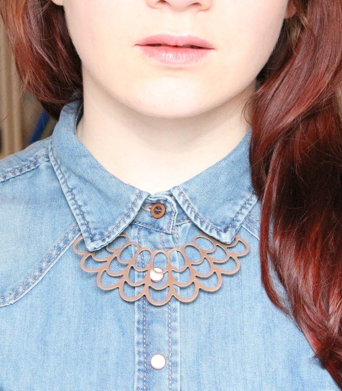 Midsection of redhead woman wearing denim top