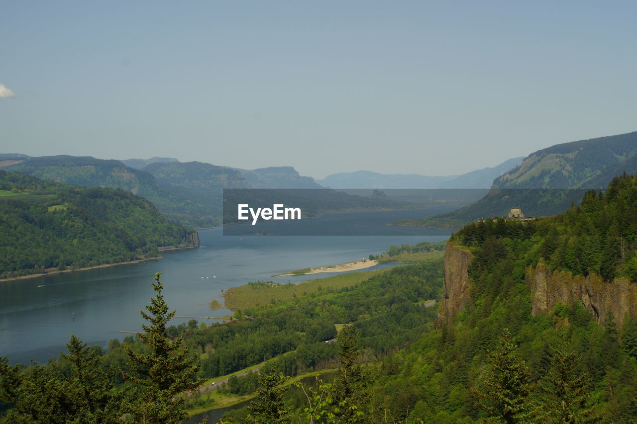 Scenic view of river and mountains against sky