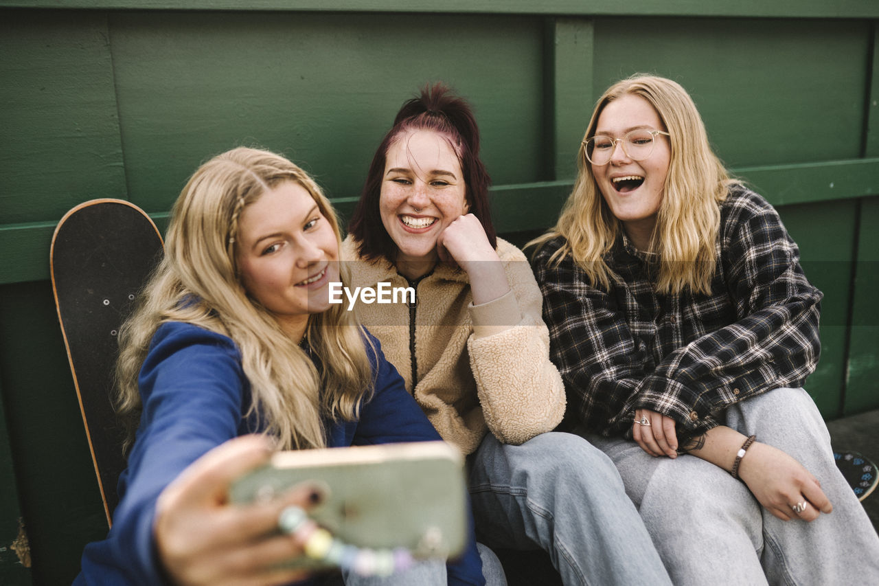 Teenage girls taking selfie with smart phone